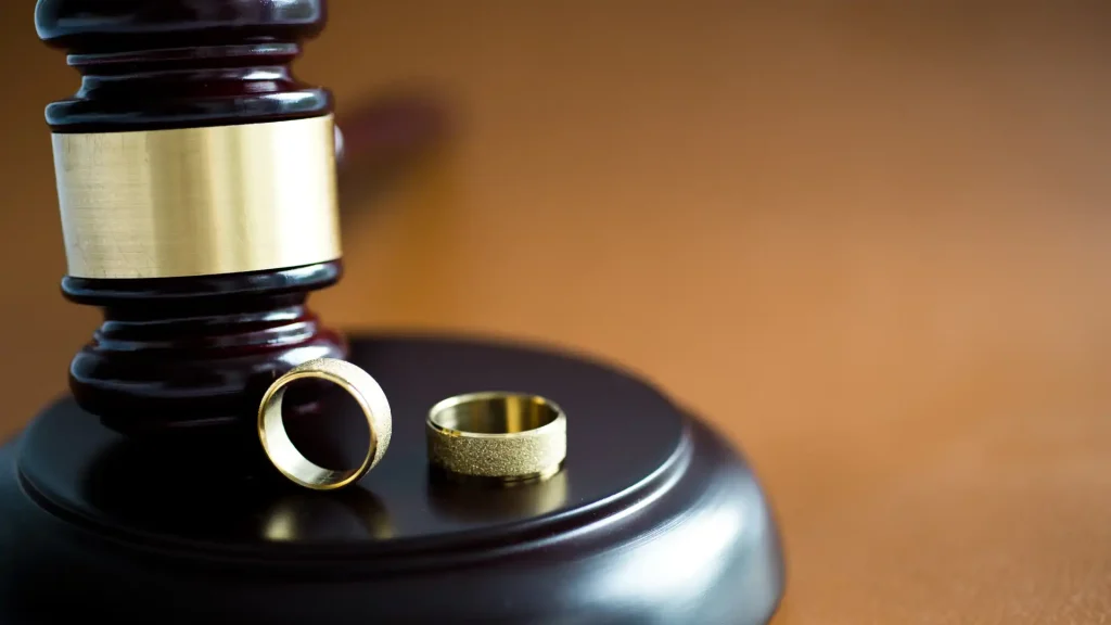 wo wedding rings resting on a gavel base